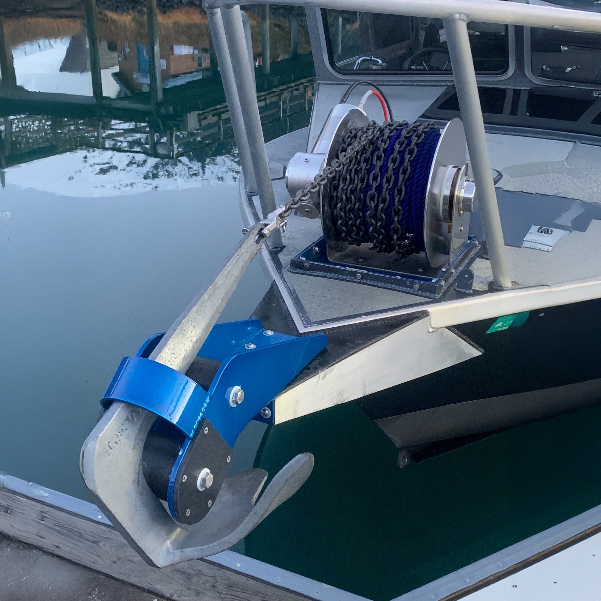 Marine winch on a boat with water and dock in the background