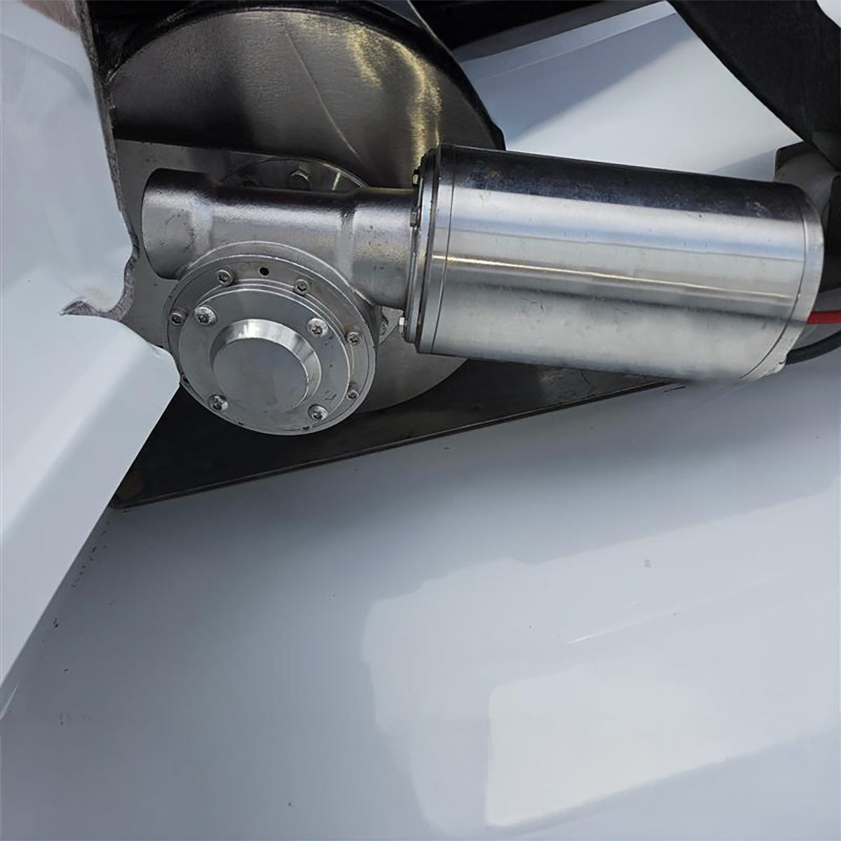 Close-up of a metallic engine component on a white background