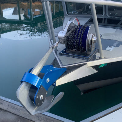 Marine winch on a boat with water and dock in the background