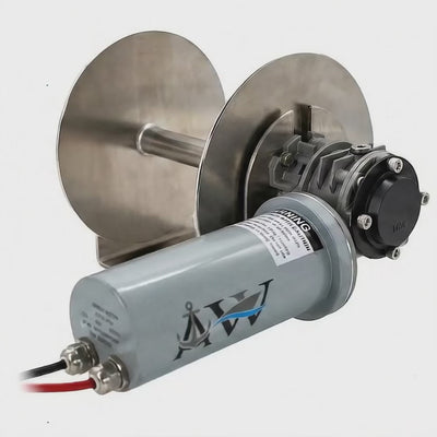 An anchor winch with a silver aluminum drum and a gray motor housing labeled 'SAILOR', featuring electrical wiring and a black handle.
